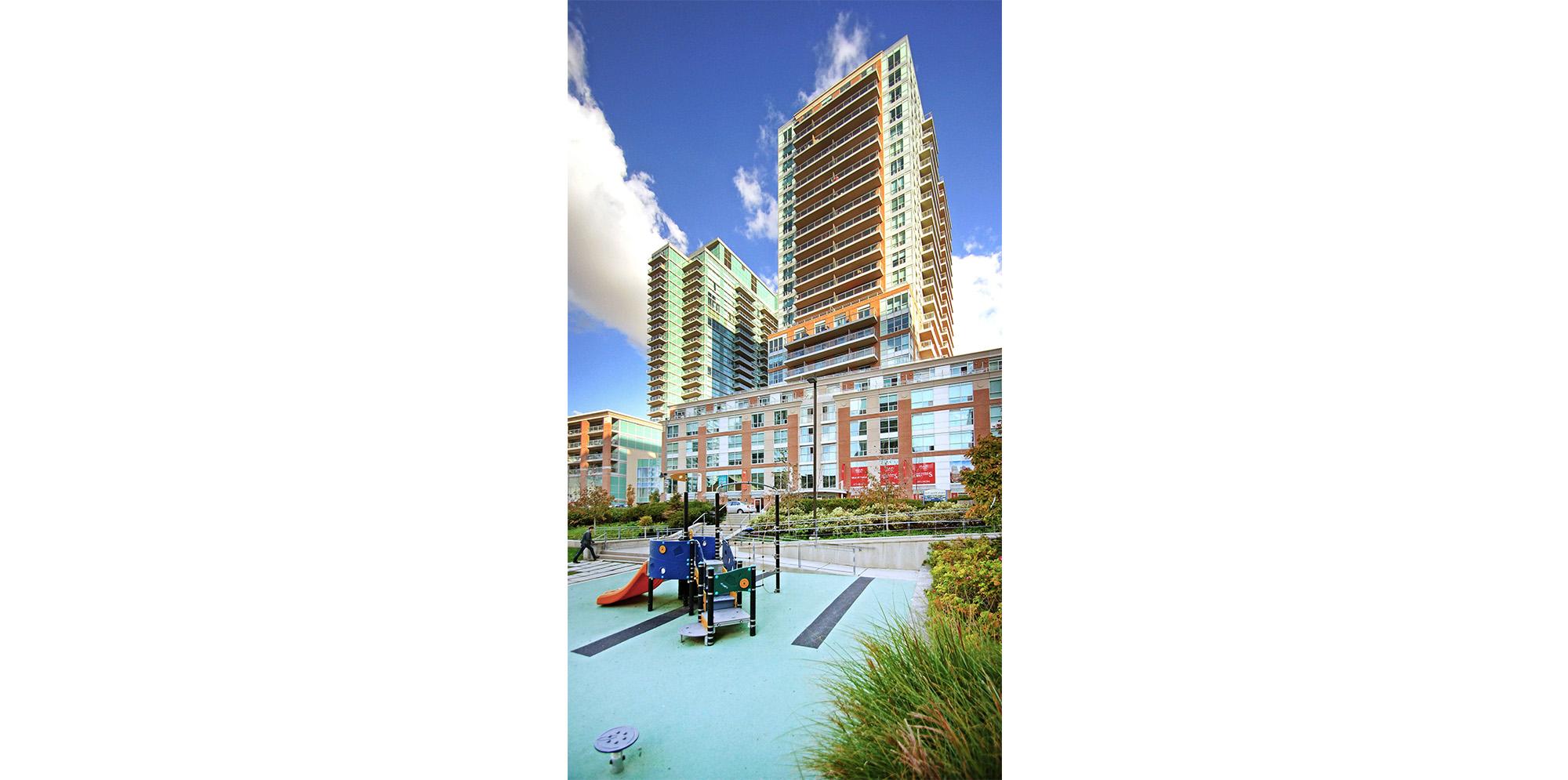 Playground in Liberty Village with apartment buildings in background